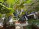 Exterior shot of the complex featuring a beautiful courtyard with lush tropical landscaping and walkways at 212 S Church Ave # 105, Tampa, FL 33609