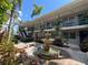 Apartment complex featuring two stories with a fountain and landscaping in the center courtyard at 212 S Church Ave # 105, Tampa, FL 33609