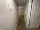 Hallway leading to rooms, featuring neutral paint, smooth floors and an electrical panel at 212 S Church Ave # 105, Tampa, FL 33609