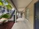 Exterior hallway featuring access to units, stairs to the upper level, and shade from the sun at 212 S Church Ave # 105, Tampa, FL 33609
