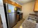 Kitchen featuring wooden cabinets, granite countertops, stainless steel appliances, and a stainless steel sink at 212 S Church Ave # 105, Tampa, FL 33609
