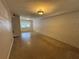 Bright living room featuring smooth flooring and natural light from the large window at 212 S Church Ave # 105, Tampa, FL 33609