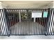 Gated parking area with security measures for residents and well-maintained red mulch at 212 S Church Ave # 105, Tampa, FL 33609