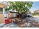 Backyard with a large tree, shed, and a partially visible home at 217 50Th N Ter, St Petersburg, FL 33703