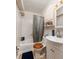 Well-lit bathroom featuring classic fixtures, a shower-tub combo, and ample storage space at 217 50Th N Ter, St Petersburg, FL 33703