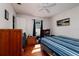 Bedroom showcasing wood floors, a striped bedspread, and natural light from the window at 217 50Th N Ter, St Petersburg, FL 33703