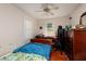 Bedroom features a ceiling fan, desk, secure storage, and natural light from two windows at 217 50Th N Ter, St Petersburg, FL 33703