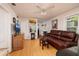 Inviting living room with hardwood floors, comfortable seating, fan, and bright windows at 217 50Th N Ter, St Petersburg, FL 33703