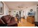Cozy living room features wood floors, a leather sofa, natural light and neutral wall paint at 217 50Th N Ter, St Petersburg, FL 33703