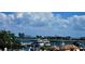 Scenic marina view with docked yachts, waterfront buildings, and a backdrop of clear blue skies with fluffy clouds at 217 50Th N Ter, St Petersburg, FL 33703
