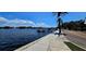 Beautiful waterfront with pier, palm trees, blue skies with clouds, and serene water along the sidewalk at 217 50Th N Ter, St Petersburg, FL 33703