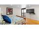Bedroom features wood floors, sliding glass door, and large TV for relaxing entertainment at 2413 Bayshore Blvd # 605, Tampa, FL 33629
