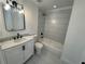 Modern bathroom featuring a white vanity, tiled shower, and sleek fixtures at 2527 13Th S Ave, St Petersburg, FL 33701