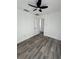 Bright bedroom featuring wood-look floors, ceiling fan, and fresh white paint at 2527 13Th S Ave, St Petersburg, FL 33701