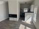 Bright living room with modern electric fireplace, wood floors, and open to the kitchen at 2527 13Th S Ave, St Petersburg, FL 33701