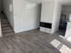 Bright living room with stairs, modern fireplace, wood floors, and open to the kitchen at 2527 13Th S Ave, St Petersburg, FL 33701