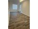 Bright, versatile room with wood floors, neutral walls, and modern air conditioning unit at 2527 13Th S Ave, St Petersburg, FL 33701