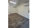 Bright, versatile room with wood floors, neutral walls, and modern air conditioning unit at 2527 13Th S Ave, St Petersburg, FL 33701