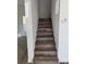 Elegant staircase featuring wood-look steps and white walls at 2527 13Th S Ave, St Petersburg, FL 33701