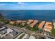 Scenic aerial shot of waterfront condominiums, pier, and stunning bay scenery with easy access to nearby conveniences at 264 Seagate Ct, Dunedin, FL 34698