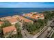 Expansive aerial view showcases the condo complex's terracotta tile roofs and waterfront location at 264 Seagate Ct, Dunedin, FL 34698