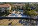 Gorgeous beachside condo featuring a community pool, private beach area, lounge seating and lush tropical landscaping at 264 Seagate Ct, Dunedin, FL 34698
