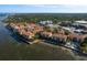Wide aerial view showcasing the entire condo complex along the bay with beautiful landscaping and beachfront at 264 Seagate Ct, Dunedin, FL 34698