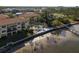 Beautiful aerial view of waterfront condos featuring a beach, pool, and lounge area with beach access and lovely bay views at 264 Seagate Ct, Dunedin, FL 34698