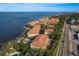 Beautiful condo community on the water featuring terracotta roofs, lush landscaping, and stunning views at 264 Seagate Ct, Dunedin, FL 34698