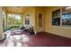 Inviting back porch with lounge chairs and a view of the landscaped backyard at 264 Seagate Ct, Dunedin, FL 34698