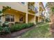 Exterior view of a building with a covered porch and landscaped backyard at 264 Seagate Ct, Dunedin, FL 34698