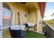 Stylish balcony with seating, faux grass flooring, and outdoor decor elements at 264 Seagate Ct, Dunedin, FL 34698