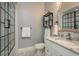 Modern bathroom featuring granite counters, shower with glass door, and vanity at 264 Seagate Ct, Dunedin, FL 34698