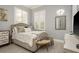 Cozy bedroom with tufted headboard, shuttered windows, and accent mirror, creating a comfortable retreat at 264 Seagate Ct, Dunedin, FL 34698