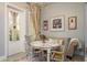 Charming breakfast nook featuring floral table, comfortable sofa, and decorative wall art at 264 Seagate Ct, Dunedin, FL 34698