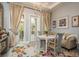 Cozy breakfast nook with floral rug, round table, sofa seating, chandelier, and access to outdoor balcony at 264 Seagate Ct, Dunedin, FL 34698