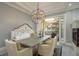 Dining room featuring an elegant chandelier and access to an outdoor balcony at 264 Seagate Ct, Dunedin, FL 34698