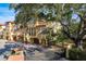 Elegant multi-story townhome featuring stucco siding, arched doorways and a secure gate at 264 Seagate Ct, Dunedin, FL 34698