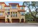 Beautiful Mediterranean-style townhome featuring arched entryways, a garage and red tile roofing at 264 Seagate Ct, Dunedin, FL 34698