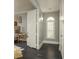 Hallway with dark wood floors, white trim, and doorway to a bedroom at 264 Seagate Ct, Dunedin, FL 34698