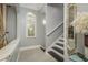 Upstairs hallway with wood-look tile flooring, natural light, and classic wall decor at 264 Seagate Ct, Dunedin, FL 34698