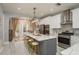Open concept kitchen showcasing an island with a marble countertop, stainless steel appliances and barstool seating at 264 Seagate Ct, Dunedin, FL 34698