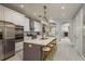 Open-concept kitchen showcasing an island with seating, stainless steel appliances, and modern cabinetry at 264 Seagate Ct, Dunedin, FL 34698