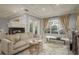 Cozy living room showcasing a fireplace, a large window, and neutral tones throughout at 264 Seagate Ct, Dunedin, FL 34698