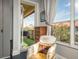 Cozy sunroom with a comfortable chair, natural light, and balcony access at 264 Seagate Ct, Dunedin, FL 34698