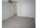 Cozy bedroom featuring carpet, a ceiling fan, and a double-door closet, perfect for organization and comfort at 4118 Dellbrook Dr, Tampa, FL 33624
