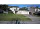 Charming two-story home with a well-maintained lawn, mature trees, and a two-car garage, perfect for families at 4118 Dellbrook Dr, Tampa, FL 33624
