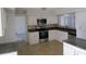 Well-appointed kitchen with granite countertops, stainless steel appliances, and ample white cabinetry, perfect for cooking at 4118 Dellbrook Dr, Tampa, FL 33624