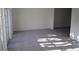 Bright and spacious living room with fresh paint, plush carpeting, and elegant french doors for seamless indoor-outdoor living at 4118 Dellbrook Dr, Tampa, FL 33624