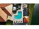 A top-down view showcases the sparkling pool surrounded by lounge areas and a scenic lake at 4228 Presidential Avenue E Cir, Bradenton, FL 34203